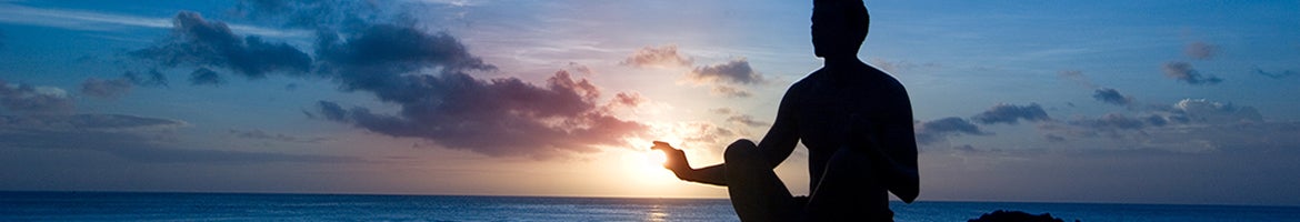 silhouette in front of dark sky and clouds